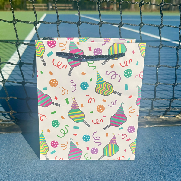 Colorful Pickleball Birthday Gift Bag with festive designs of paddles, party hats, and confetti.