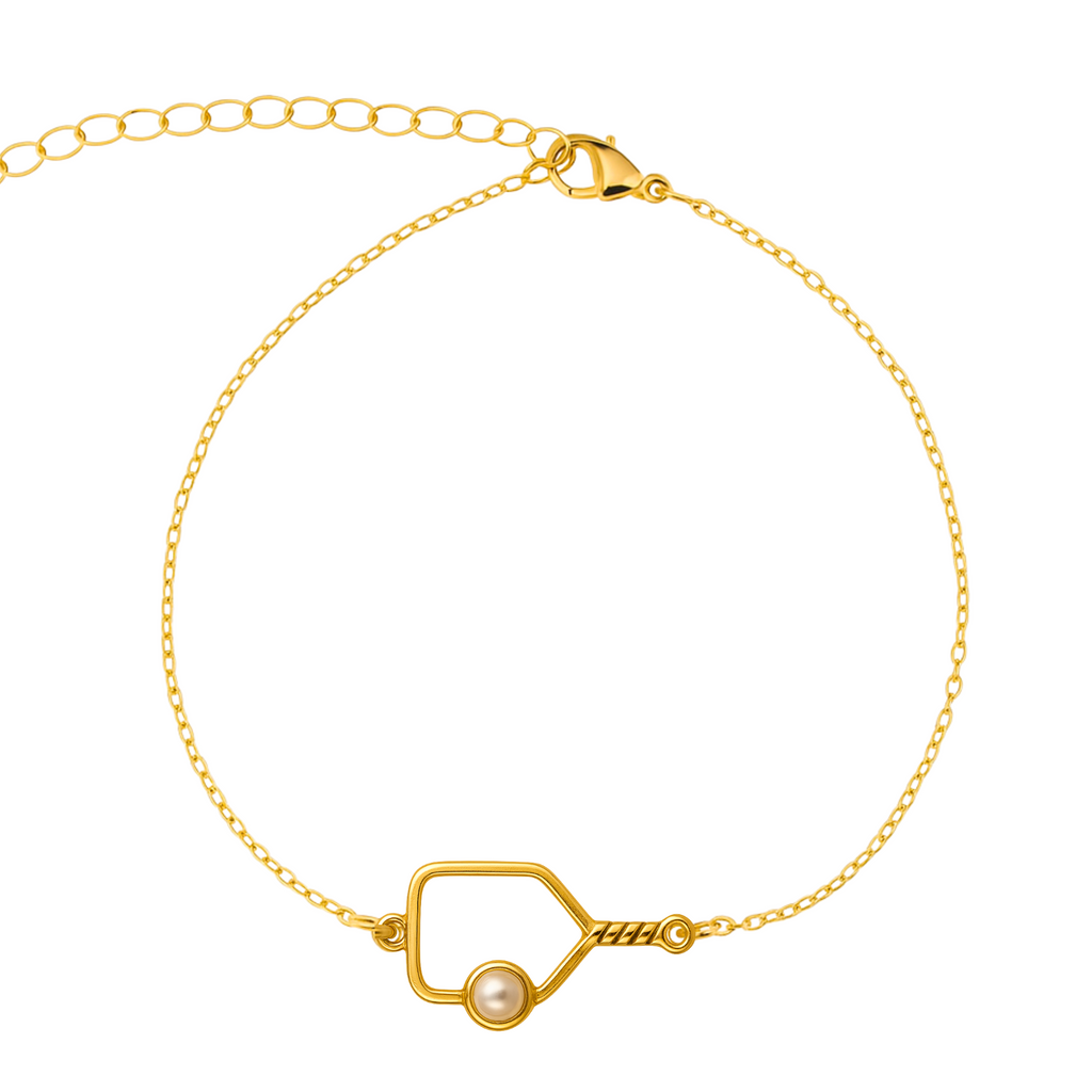 Elegant gold pickleball bracelet with an open paddle charm featuring a pearl ball detail and twisted handle, adjustable chain clasp, stylish jewelry gift for pickleball fans