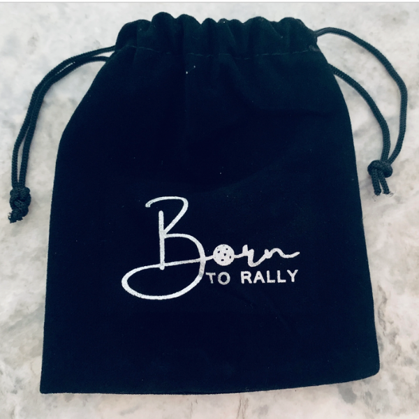 Black drawstring pouch with 'Born to Rally' embroidered design, perfect for storing racing accessories.