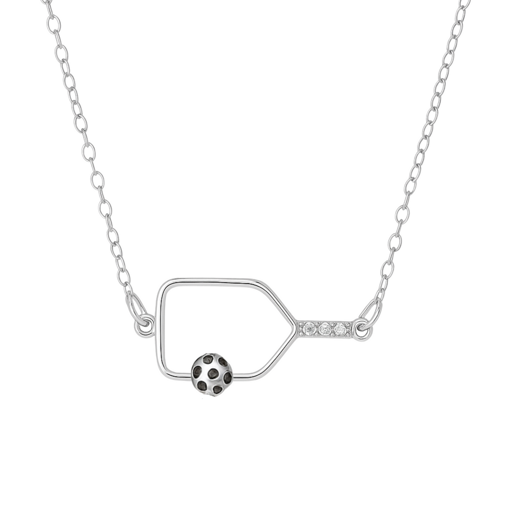 Delicate silver pickleball paddle necklace with an attached pickleball charm, minimalist jewelry for pickleball players and enthusiasts.