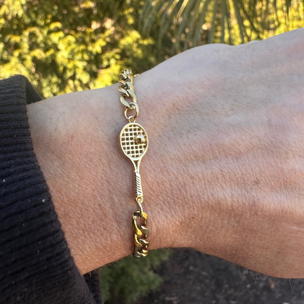 Gold adjustable tennis racket bracelet showcasing tennis jewelry on wrist, ideal tennis gift for enthusiasts.