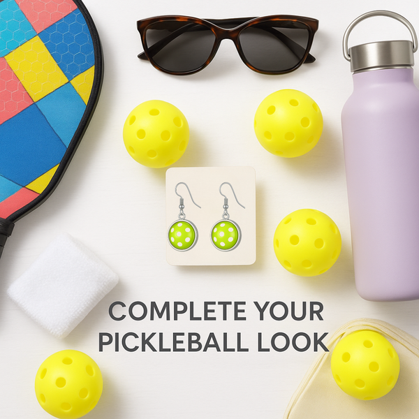 Pickleball ball dangle earrings displayed among sports accessories, perfect pickleball jewelry for women.