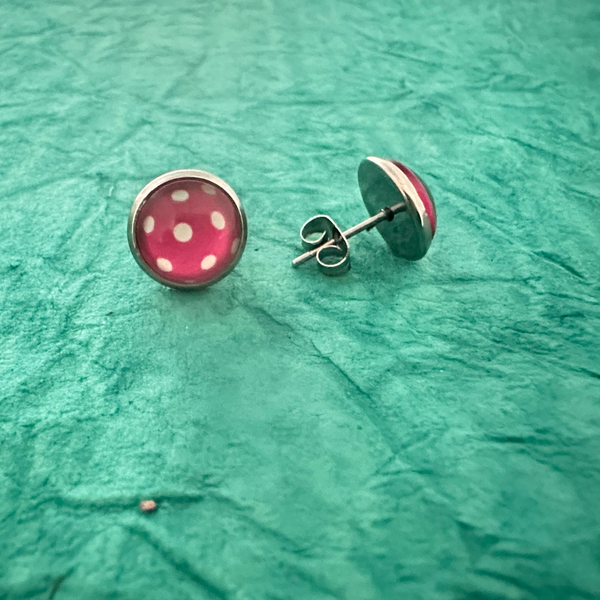 Pickleball cabochon stud earrings in pink with white polka dots, ideal pickleball jewelry and accessories for women.
